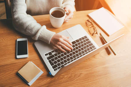 Young woman working in a home office on her laptop computer. Remote work concept.の写真素材