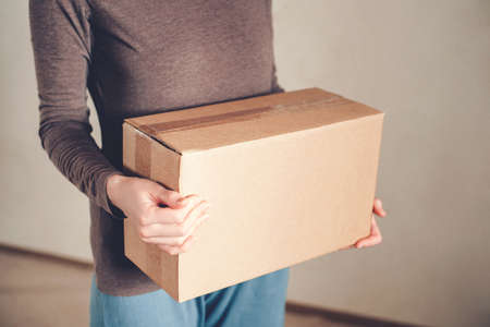 Womens hands hold the box with the delivered order. The concept of delivery.の写真素材