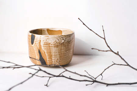 Handmade ceramics in the style of wabi sabi. Brown clay bowl with an abstract pattern.の写真素材