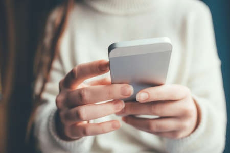 Womens hands use a smartphone for online shopping, social networking, or remote work. Close up image.の写真素材