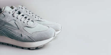 Gray sneakers on a gray background. A trending monochrome image for your design.の写真素材