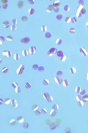 Pearl confetti on blue background. Flat lay, top view.の写真素材