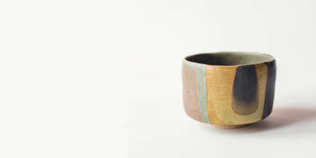 Handmade ceramics in the style of wabi sabi. Brown clay bowl with an abstract pattern.の写真素材