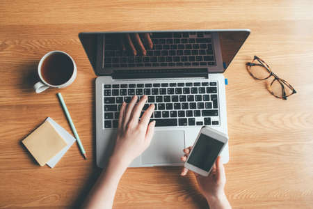 Young woman working in a home office. Remote work concept. Top view.の写真素材