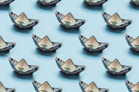 Pattern of 100 dollar bills in the shape of a ship. Financial and economic concept.の写真素材