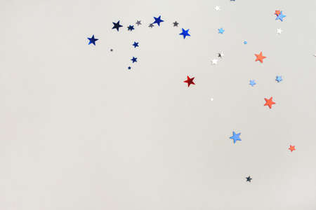 Festive background with confetti in the shape of stars in the color of the American flag. US independence day.の写真素材
