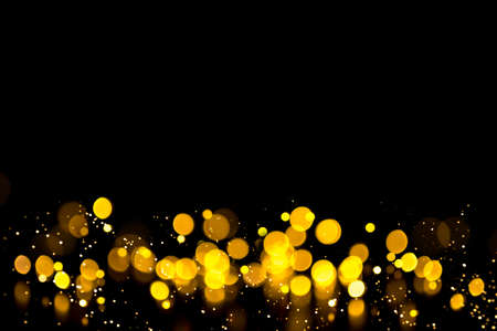 Golden abstract bokeh on black background. Holiday conceptの写真素材