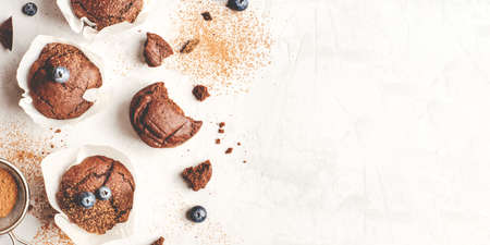 Homemade fresh chocolate muffins with berries and chocolate pieces. Top view.の写真素材