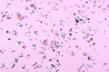 Multicolored confetti on pink background. Flat lay, top view.の写真素材