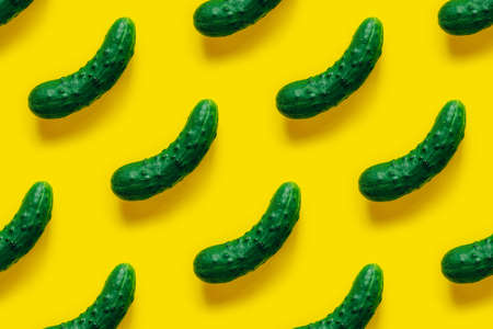 Pattern of ripe cucumber on yellow background. Flat lay.の写真素材