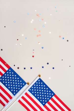 Festive background with US flags and confetti in the shape of stars. US independence day concept.の写真素材