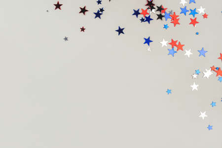 Festive background with confetti in the shape of stars in the color of the American flag. US independence day.の写真素材