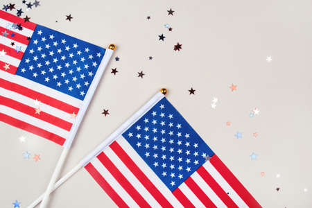 Festive background with US flags and confetti in the shape of stars. US independence day.の写真素材