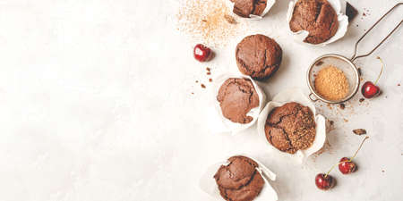 Homemade fresh chocolate muffins with berries and chocolate pieces. Top view.の写真素材
