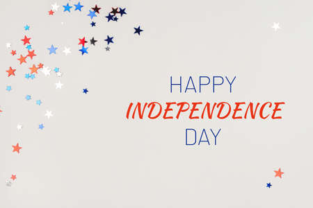 Festive background with confetti in the shape of stars in the color of the American flag. US...