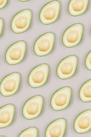 Pattern of fresh green avocado on a grey background. Top view.の写真素材