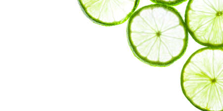 Green lime slices isolated on white background. Food texture. Copy space for text.の写真素材