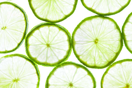 Green lime slices isolated on white background. Food texture.の写真素材