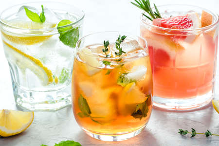 Summer refreshing fruit drinks with ice on a grey background.の写真素材