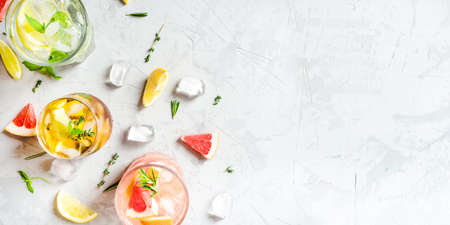 Refreshing fruit drinks with ice on a grey background. Flat lay, top view. Banner with copy space.の写真素材
