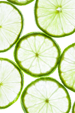 Green lime slices isolated on white background. Food texture.の写真素材