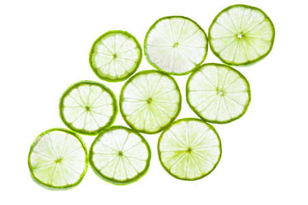 Green lime slices isolated on white background. Food texture.の写真素材