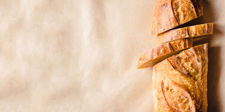 Fresh sliced bread on kraft paper. Close up. Banner with copy space for text.の写真素材