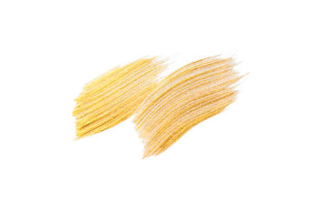 Gold acrylic brushstroke isolated on a white background.の写真素材