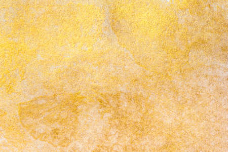 Aged texture created with gold acrylic paint. Festive background.の写真素材