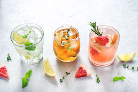 Summer refreshing fruit drinks with ice on a grey background.の写真素材