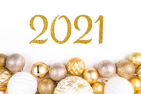 New year 2021. Festive white background with golden Christmas balls.