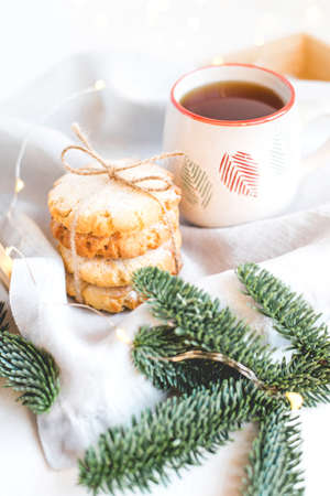 Composition of fresh cookies and fir branches on a wooden tray. Christmas concept. Close up.の写真素材