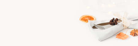 Thanksgiving autumn background. Cutlery and napkin decorated with autumn leaves and spices. Front view. Close up.の写真素材