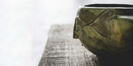 Handmade ceramics in the style of wabi sabi. Clay bowl with an face. Zen, Buddhism, meditation concept.の写真素材