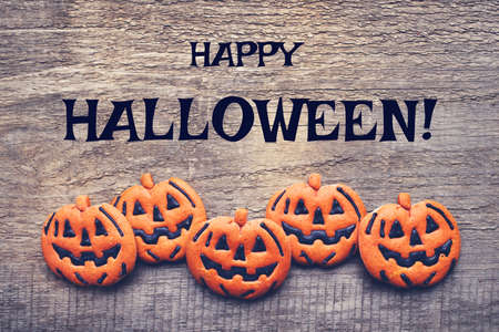 Halloween gingerbread cookies on wooden background. Flat lay. Copy space for your text.の写真素材