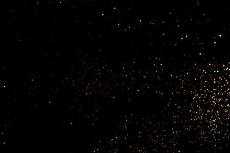 Golden abstract bokeh on black background. Holiday concept.の写真素材
