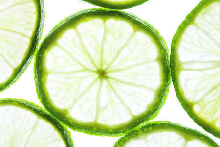 Green lime slices isolated on white background. Food texture.の写真素材