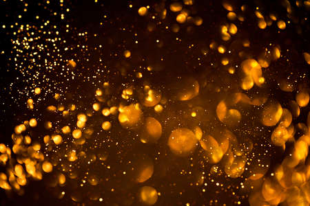 Golden abstract bokeh on black background. Holiday conceptの写真素材