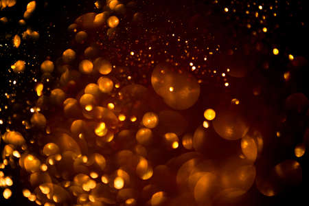 Golden abstract bokeh on black background. Holiday conceptの写真素材