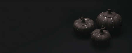 Ceramic pumpkins with rhinestones on a black background. Minimalistic background for autumn holidays with space for text.の写真素材