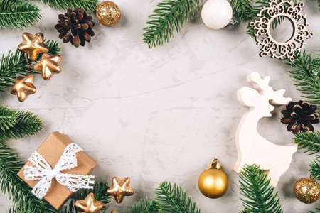 Christmas background of fir tree branches and decorations. The concept of the winter holidays. Flat lay, top view, copy space.の写真素材