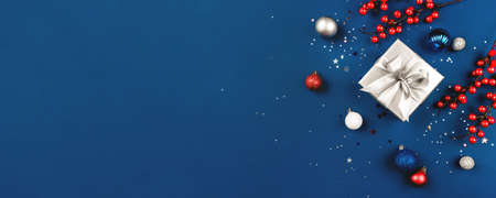 Blue Christmas background of gift box and decorations. The concept of the winter holidays. Flat lay, top view, copy space.の写真素材