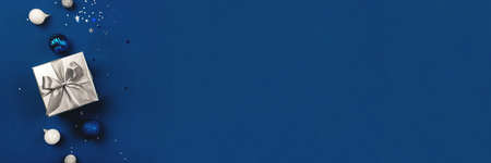 Blue Christmas background of gift box and decorations. The concept of the winter holidays. Flat lay, top view, copy space.の写真素材