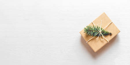 Christmas gift with fir branch on white background. Flat lay, top view. Copy space foryour text.の写真素材