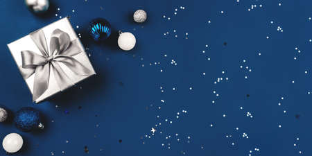 Blue Christmas background of gift box and decorations. The concept of the winter holidays. Flat lay, top view, copy space.の写真素材