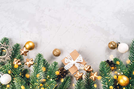 Christmas background of fir tree branches and decorations. The concept of the winter holidays. Flat lay, top view, copy space.の写真素材