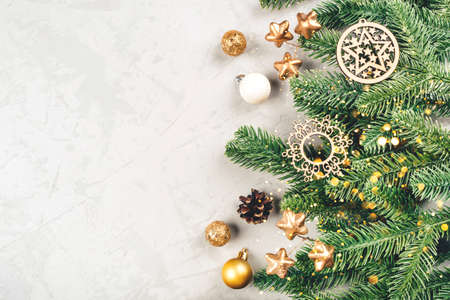 Christmas background of fir tree branches and decorations. The concept of the winter holidays. Flat lay, top view, copy space.の写真素材