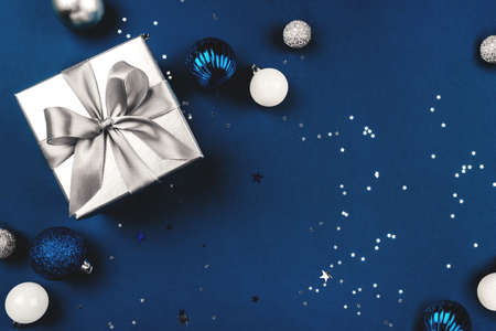 Blue Christmas background of gift box and decorations. The concept of the winter holidays. Flat lay, top view, copy space.の写真素材