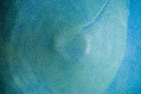 Handmade ceramics in the style of wabi sabi. Blue clay bowl with an abstract pattern. Top view.の写真素材