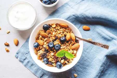 Baked granola with yogurt and blueberries on a gray table. Top view.の写真素材